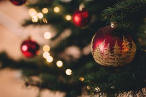 A closeup of a bauble hanging on a Christmas tree