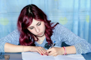 A person writing something in a book