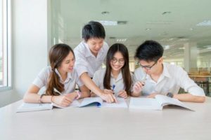 Group of students studying together in a hall