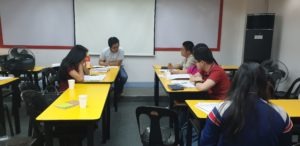 A group of people in a classroom in a discussion