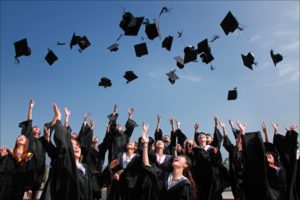 Graduate students throwing their hats in the air