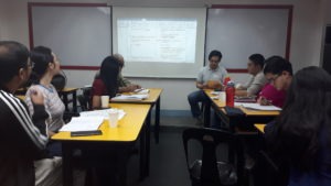People in a classroom discussing the answers of a test