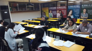 A classroom with people taking exams