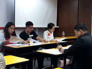 People in a classroom answering a test