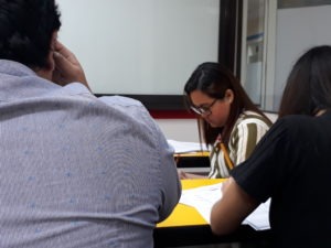 People in a classroom answering a test