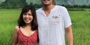 Two people side-hugging on a field