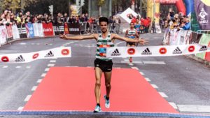 A runner finishing a marathon on the finish line