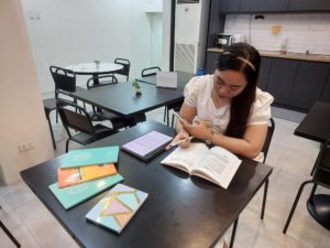 A student reviewing with textbooks and a tablet