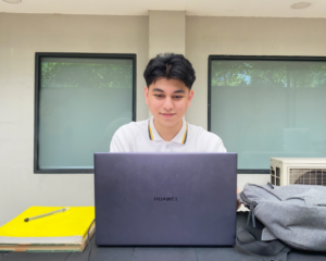 A student looking at their laptop