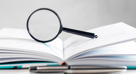 Book with magnifying glass