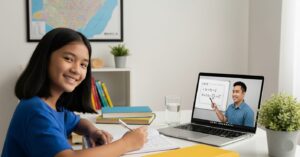 A student taking an online tutorial, while taking notes
