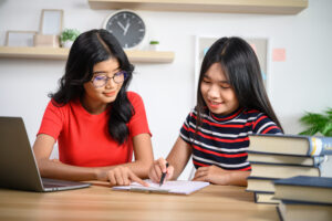 Two people studying, pointing at a checklist