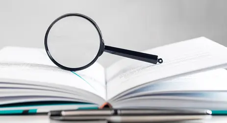 Book with magnifying glass